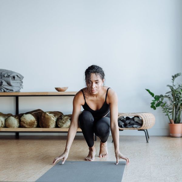 A focused young person holding a warrior yoga pose.